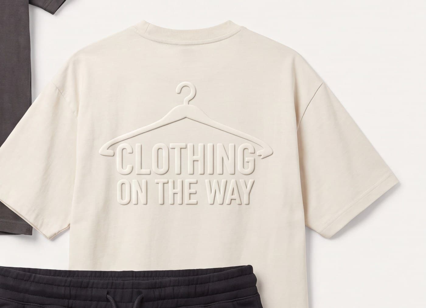 Back-print embossed tee in bone with the full hanger mark